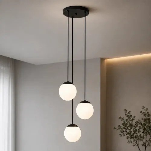 Pendente com três globos de vidro branco pendurados em alturas diferentes e canopla preta, foto do anúncio do produto no Mercado Livre